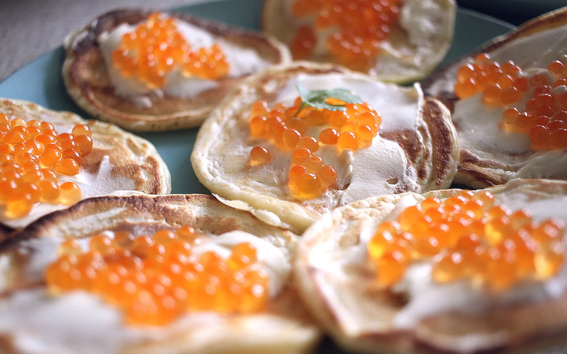 Closeup of pancakes with sourcream and caviar.