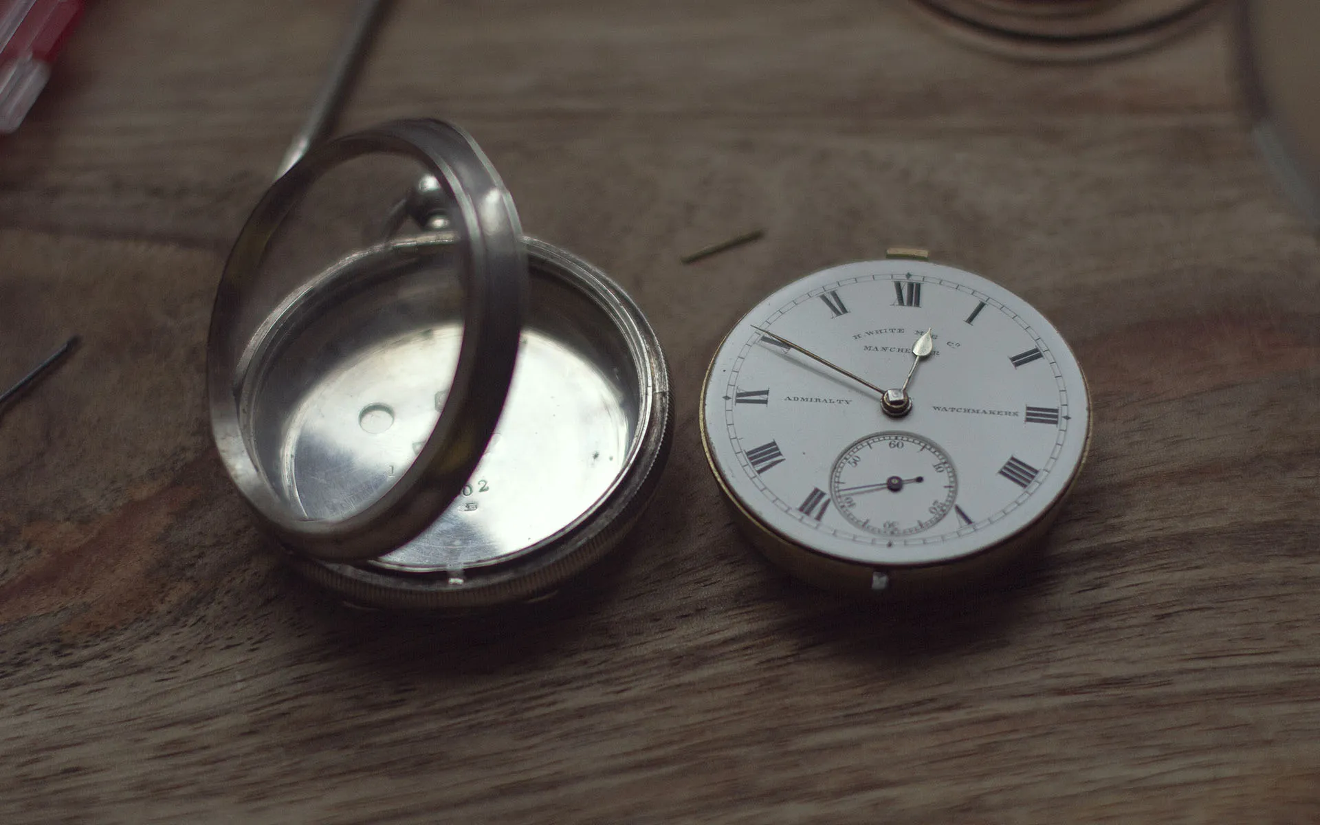 Mechanical pocket watch mechanism removed from it's silver case.