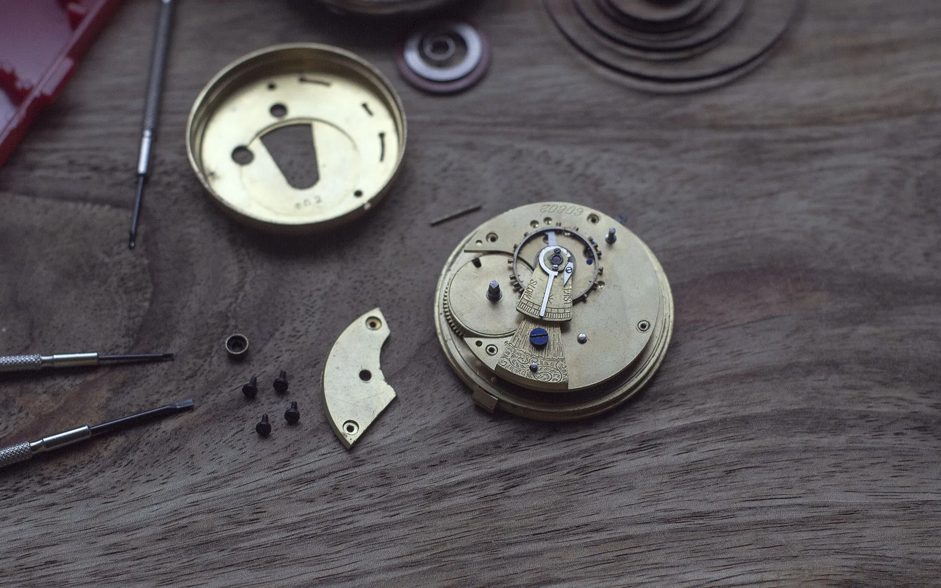 Mechanical watch mechanism with backplate removed, gears showing.