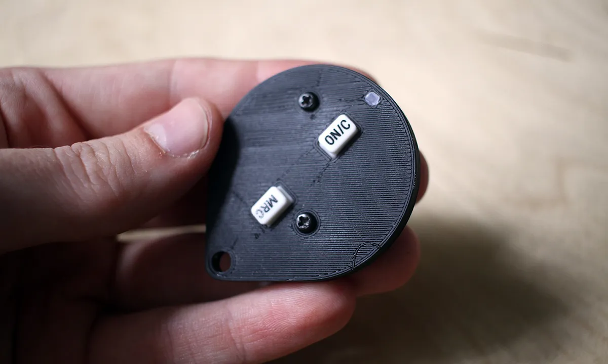 3D printed and assembled garage remote in hand. Open and Close buttons are ON/C and MRC buttons from a calculator.
