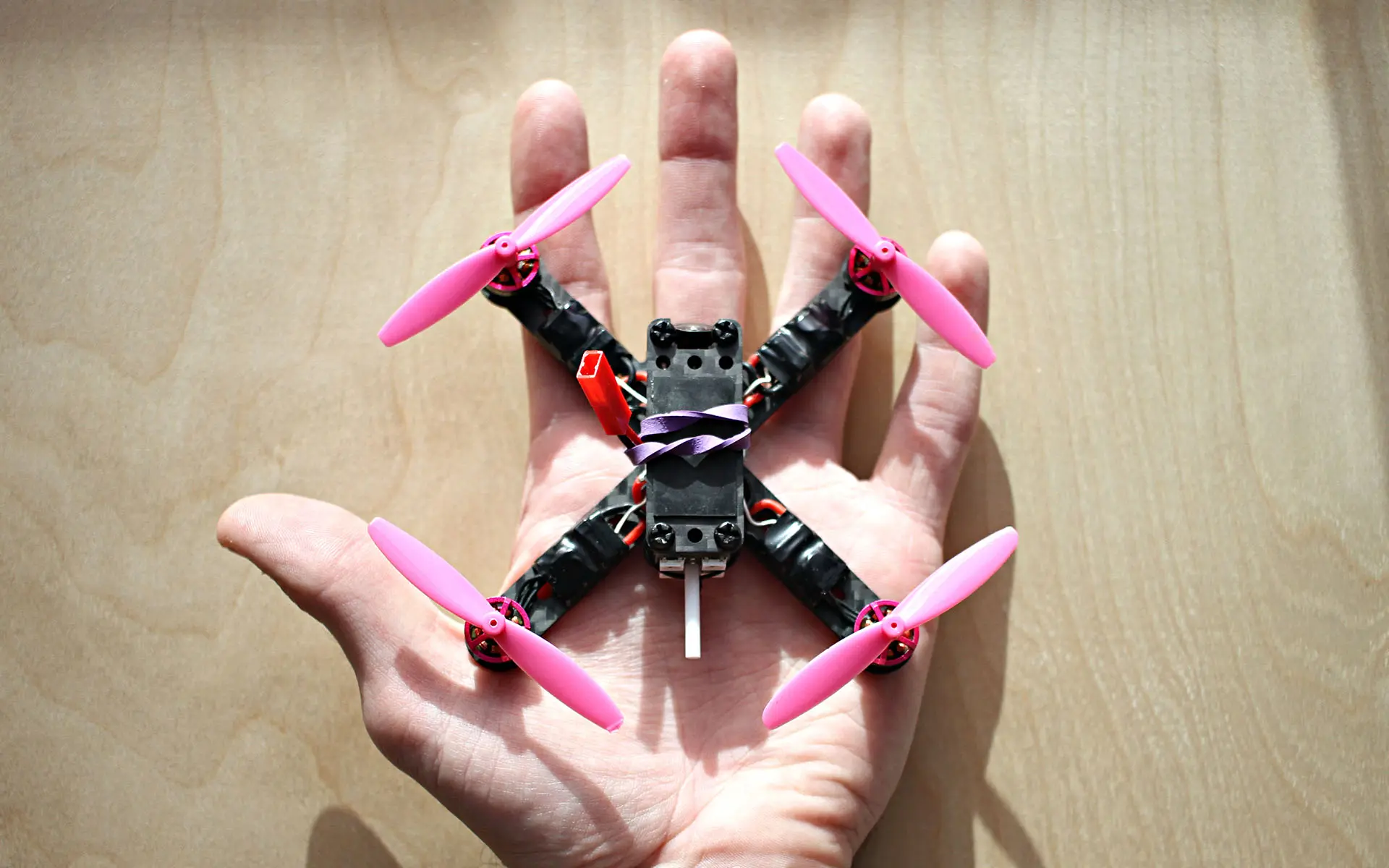 Top down view of a 2.5" drone in the palm of a hand.
