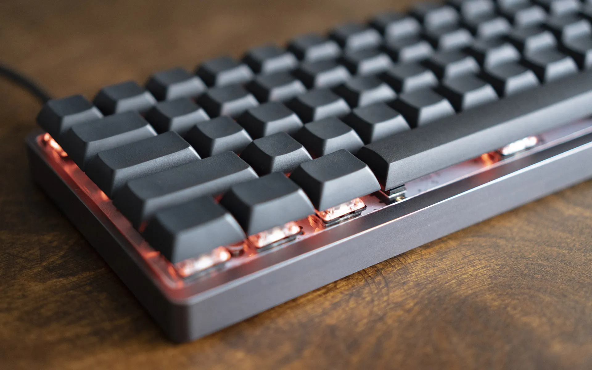 Closeup of matte black keycaps of a keyboard, with no legends printed on them.