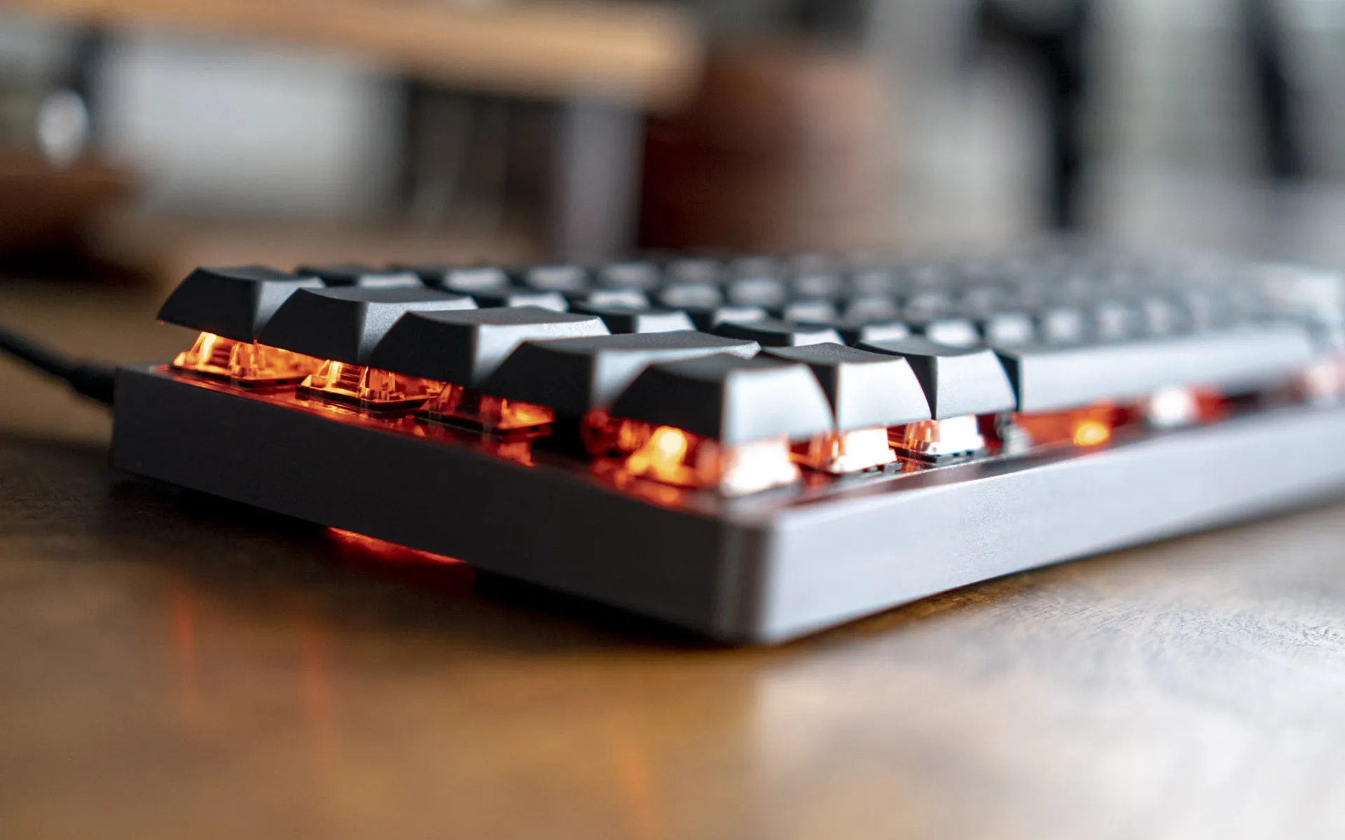 Closeup of the red glow under the keycaps of a mechanical keyboard.