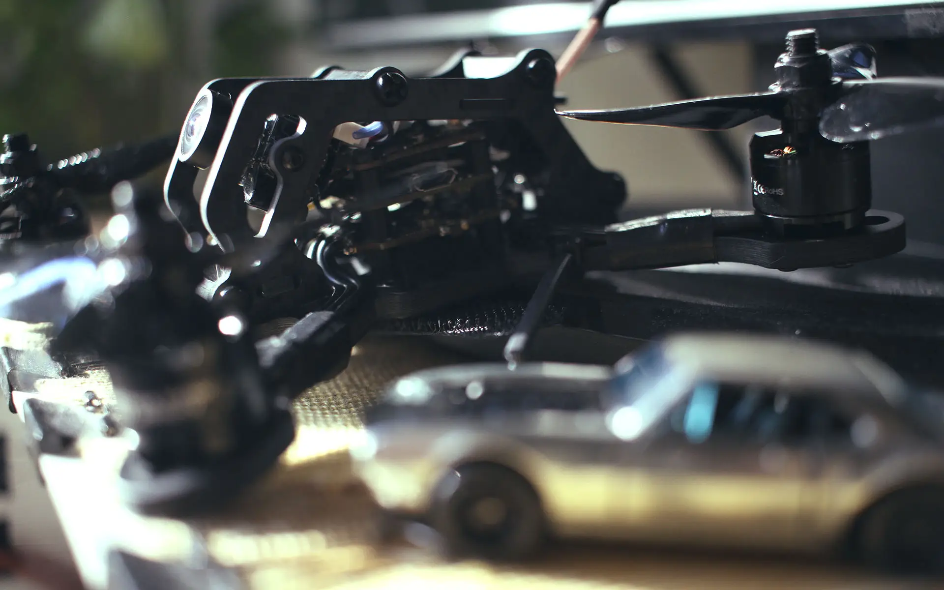 Closeup shot of a 3 fpv racing drone, side view.